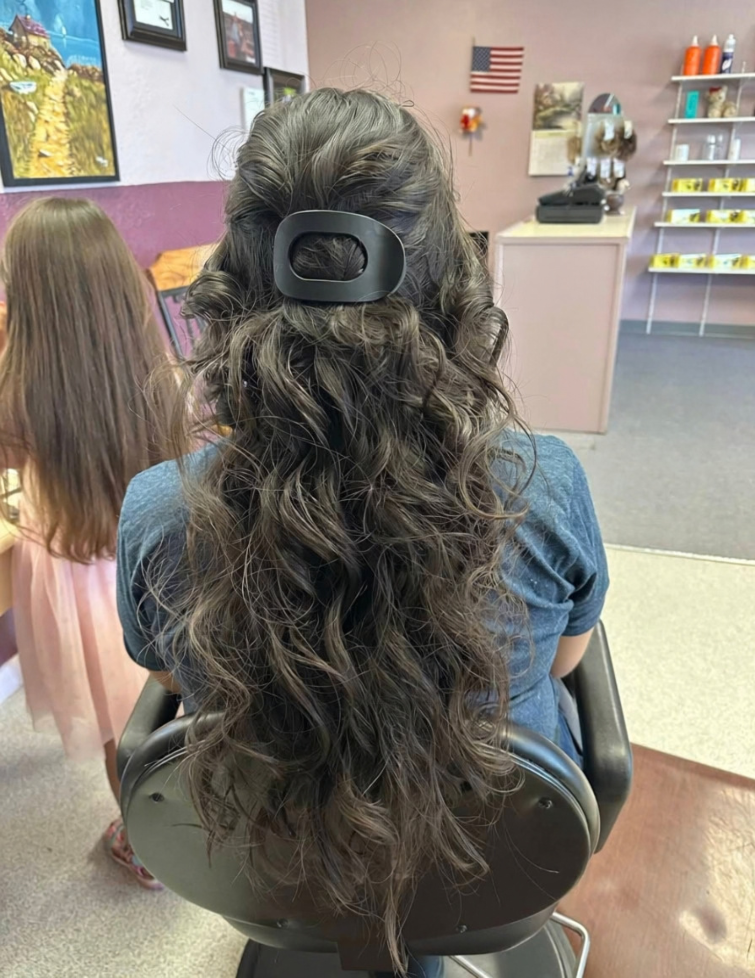 Half-up hairstyle with dark curls